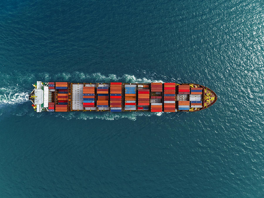 Aerial view of cargo ships in containers sailing in the sea. #1 Photograph by Nittaya Singhaseri