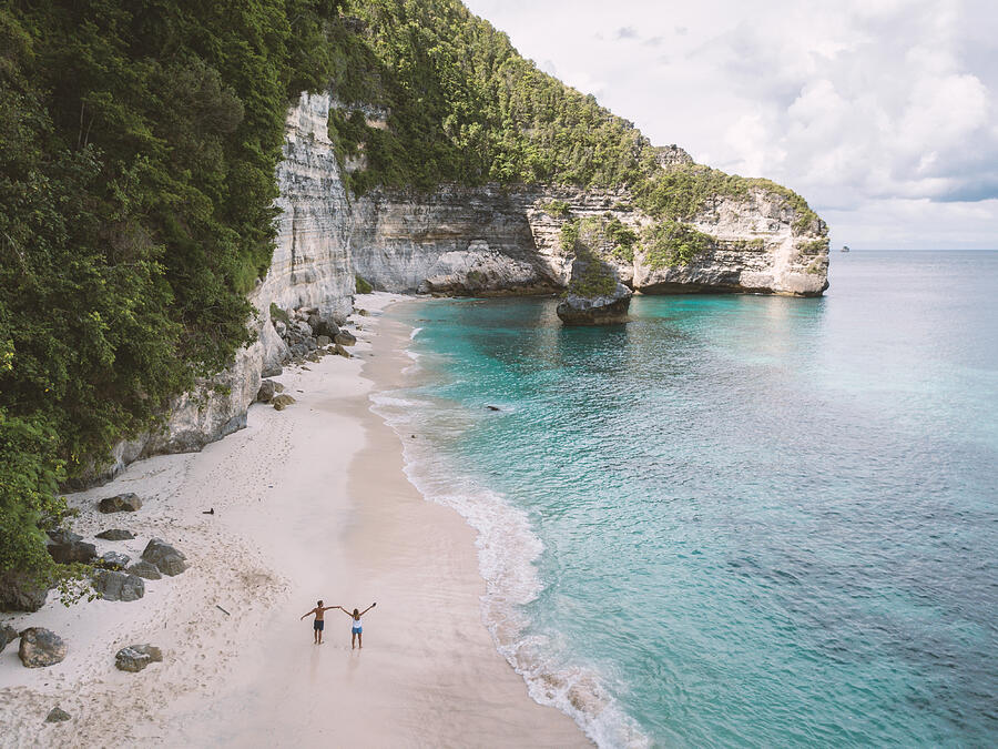 Aerial view of young couple on tropical beach enjoying vacations and nature, people travel exploration concept #1 Photograph by Swissmediavision