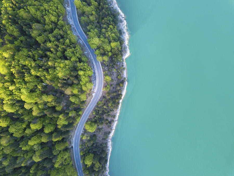 Aerial view on turquoise Lake Sylvenstein and forest with road on the bay. Germany, Bavaria, Lake Sylvenstein #1 Photograph by Malorny