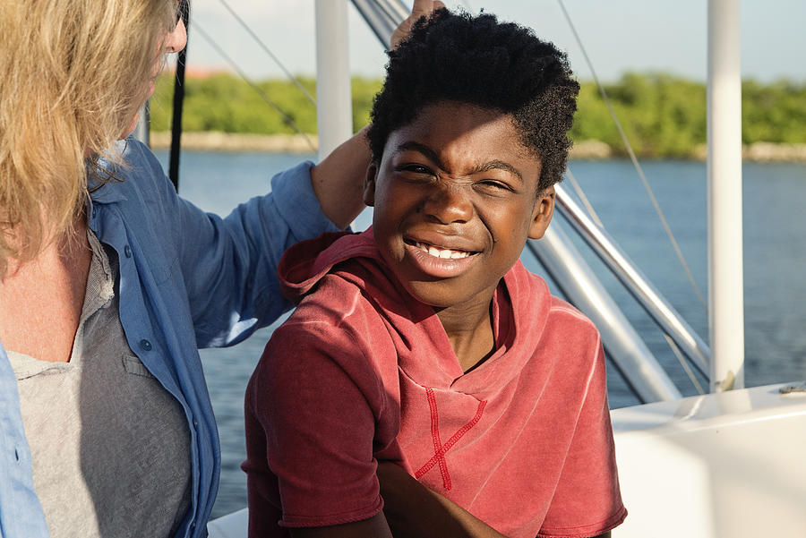 African-american boy on a fishing trip with mother. #1 Photograph by Martinedoucet