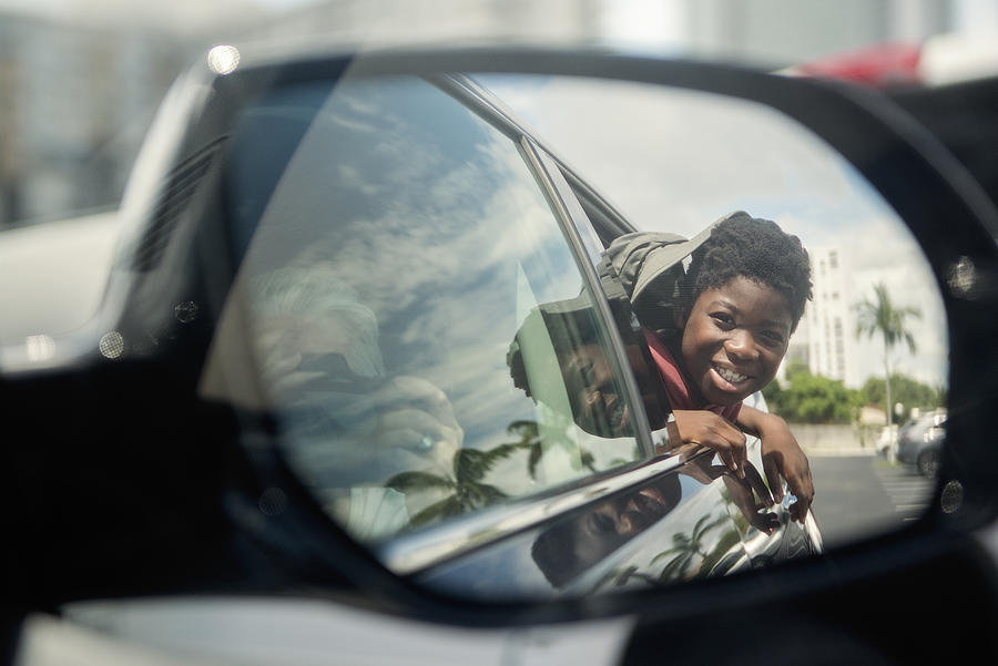 African-american boy on the back seat of a car. #1 Photograph by Martinedoucet