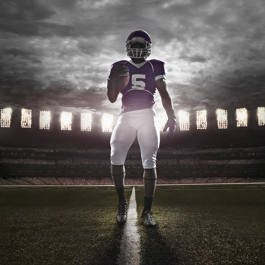 African American football player illuminated on field #1 Photograph by John Fedele