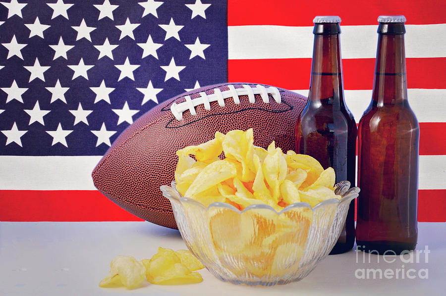American football with beer and chips. #1 Photograph by Milleflore Images