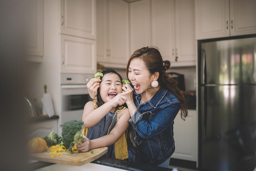 An Asian Chinese housewife having bonding time with her daughter in kitchen preparing food #1 Photograph by Chee Gin Tan