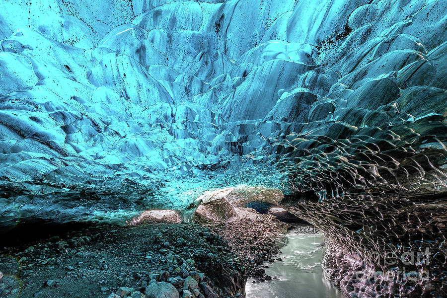 An icy river carries melt water through an ice cave in the glaci #1 Photograph by Jane Rix
