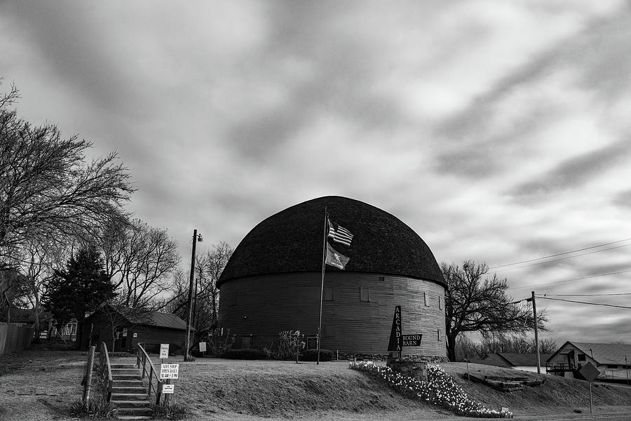 Arcadia Round Barn on Historic Route 66 in Arcadia Oklahoma in black and white #1 Photograph by Eldon McGraw