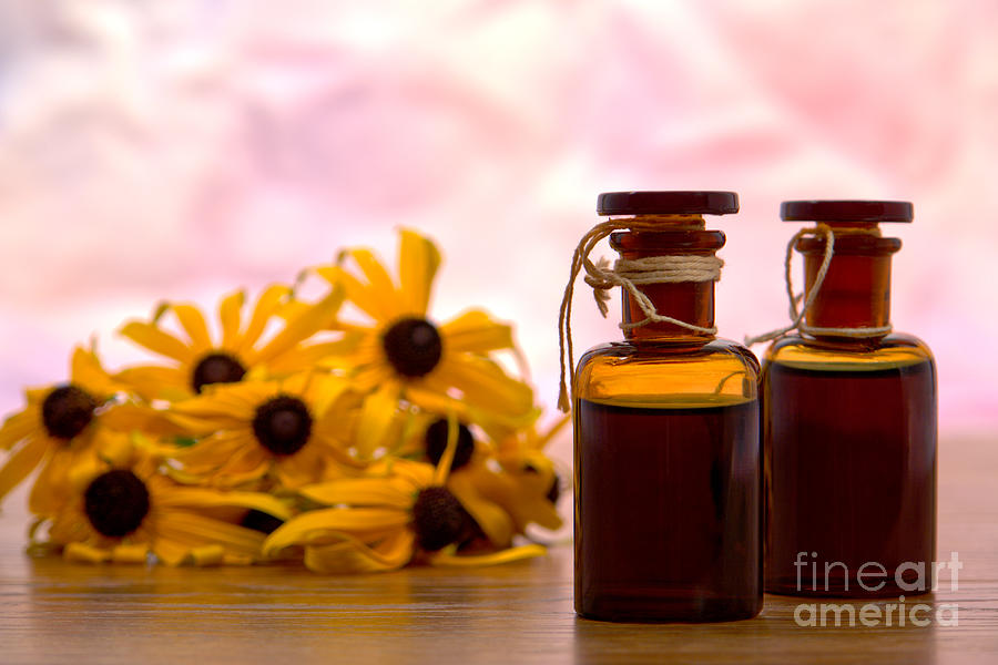 Amber Aromatherapy Bottle with Flower Background Photograph by Olivier Le Queinec