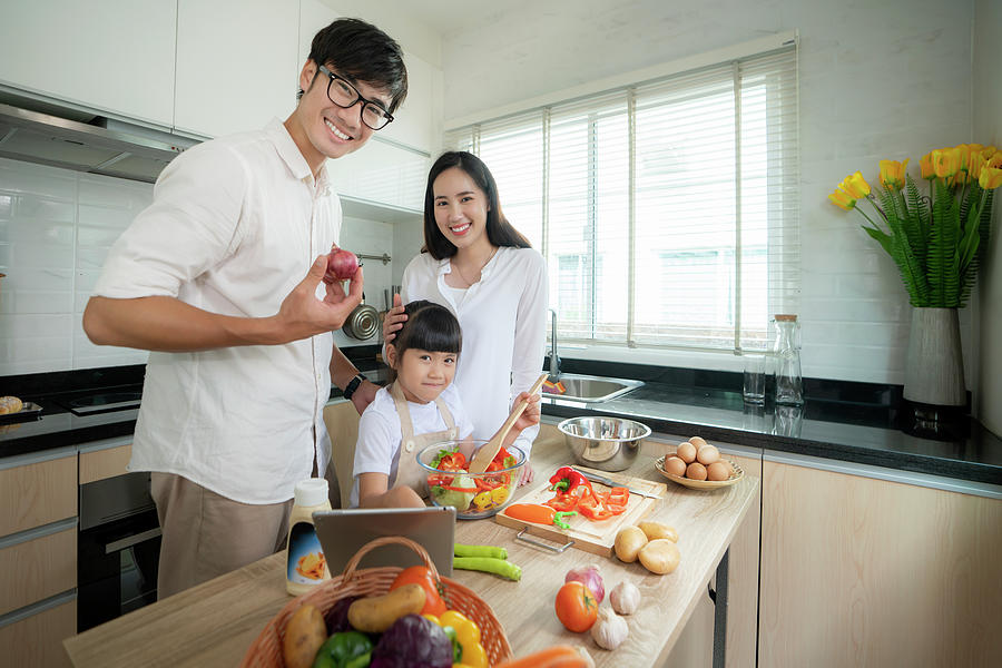 Asian family and her daughter enjoy cooking togather Photograph by Anek ...