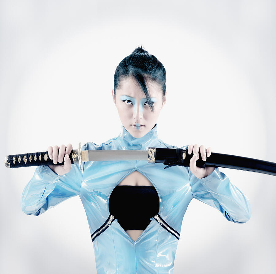 Asian woman holding samurai sword #1 Photograph by Colin Anderson Productions pty ltd