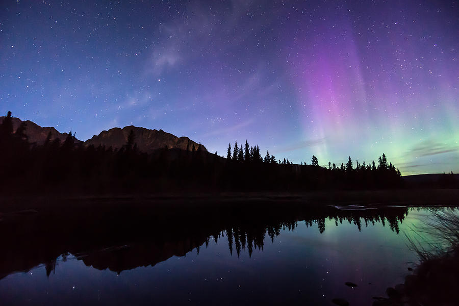 Aurora borealis (Northern lights) reflect in mountain lake #1 Photograph by AscentXmedia