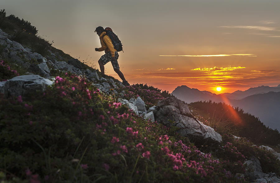 Austria, Salzburg Country, Man hiking through Niedere Tauern mountains at sunrise #1 Photograph by Westend61
