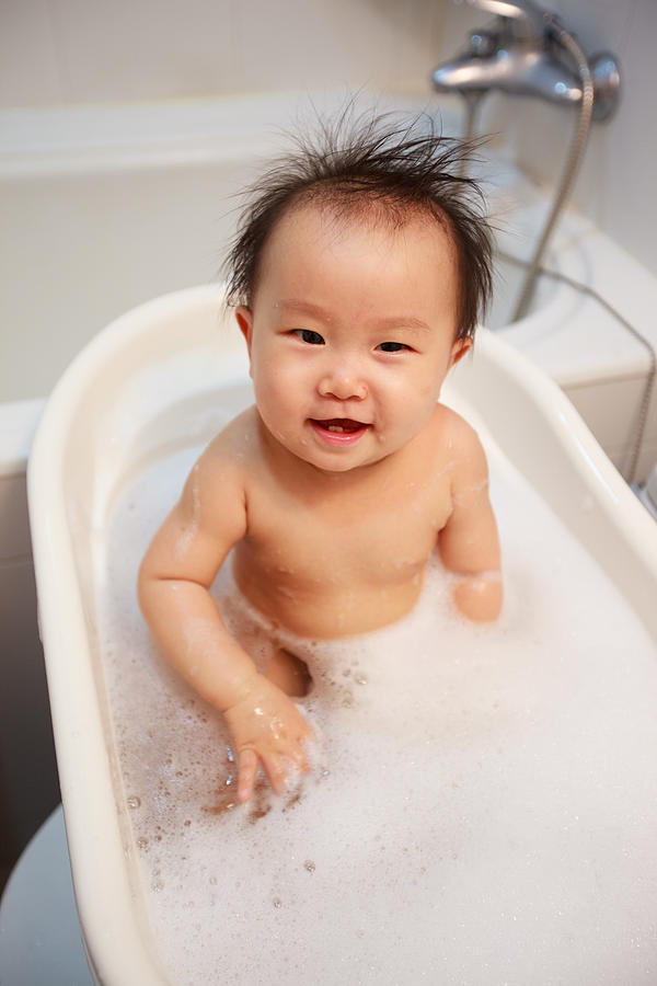 Baby girl taking bath #1 Photograph by Photo by Stanley Yao