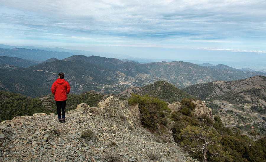 Back view of a woman standing on rocky top y enjoying mountain range panorama. Hiking traveling and climbing #1 Photograph by Michalakis Ppalis