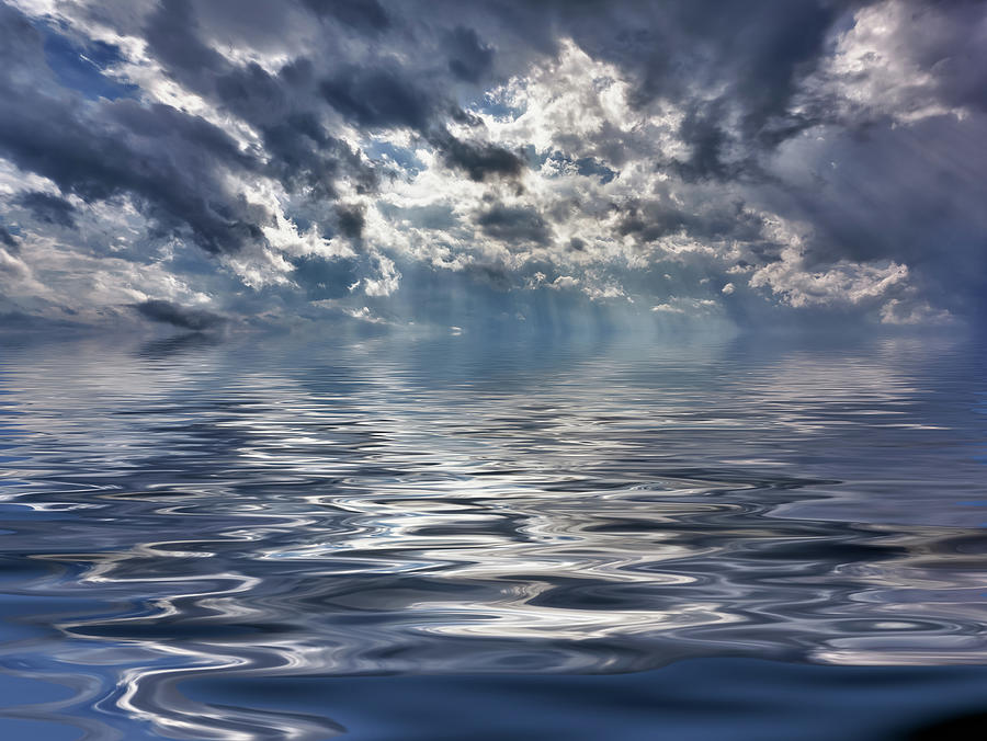 Background image of stormy sky over a calm and reflective ocean #1 Photograph by Steven Heap