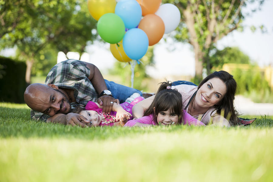 Beautiful family at picnic playing with balloons #1 Photograph by Vesnaandjic