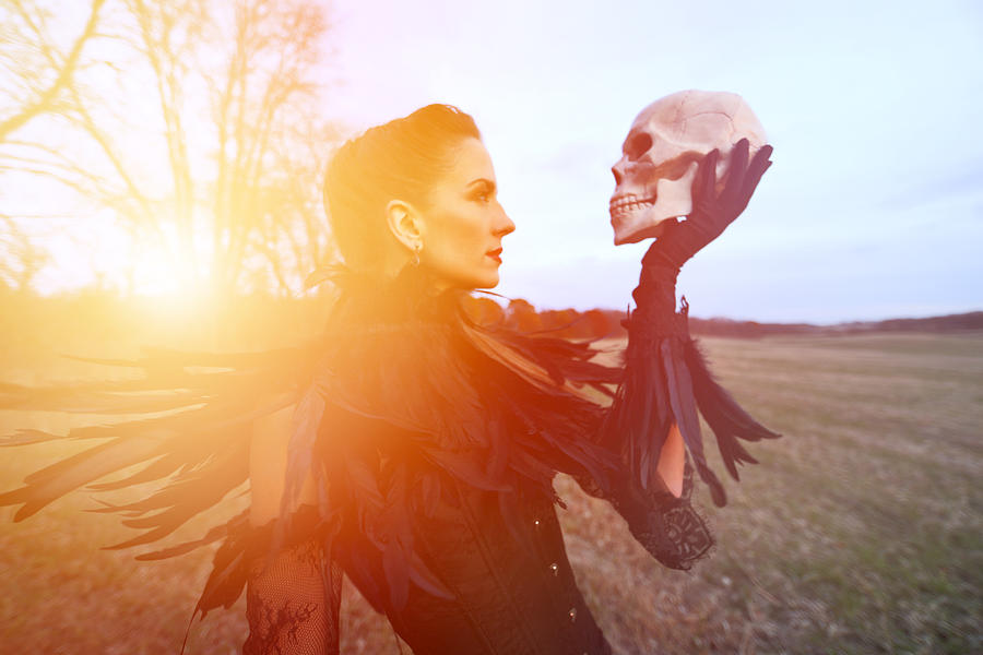 Beautiful Gothic style woman holding skull #1 Photograph by GeorgePeters