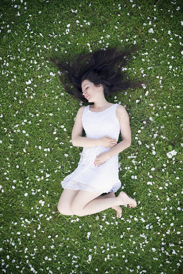 Beautiful woman lying in apple blossoms #1 Photograph by Altmodern