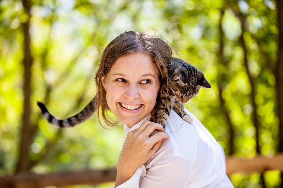 Beautiful Young Woman Enjoying with her Cat on Shoulders #1 Photograph by CasarsaGuru