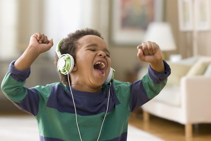 Black boy listening to music on headphones #1 Photograph by Jose Luis Pelaez Inc