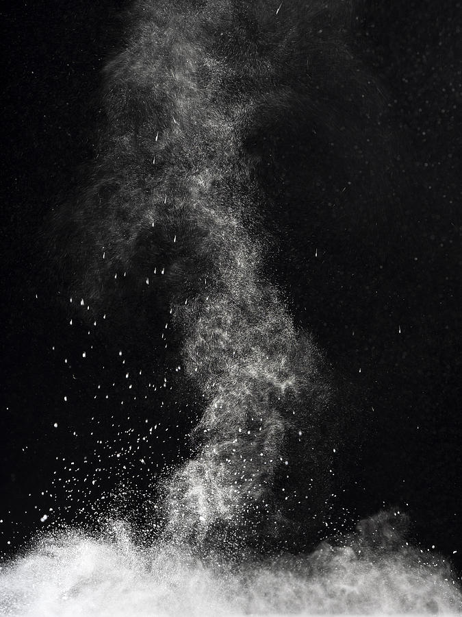 Blackground of particles of white powder in ascending movement floating in the air #1 Photograph by Jose A. Bernat Bacete