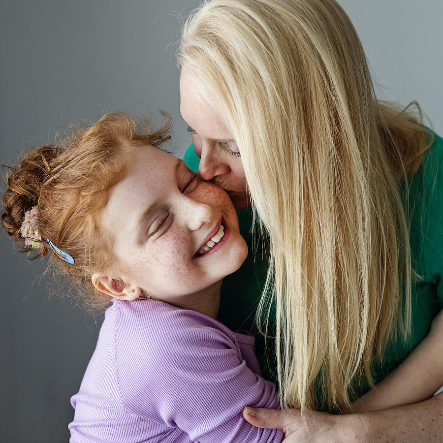 Blonde mother and expressive preteen redhead daughter portrait. #1 Photograph by Martinedoucet