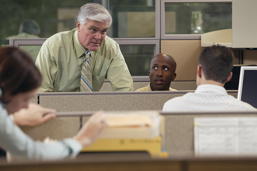 Boss talking to employees #1 Photograph by Comstock Images