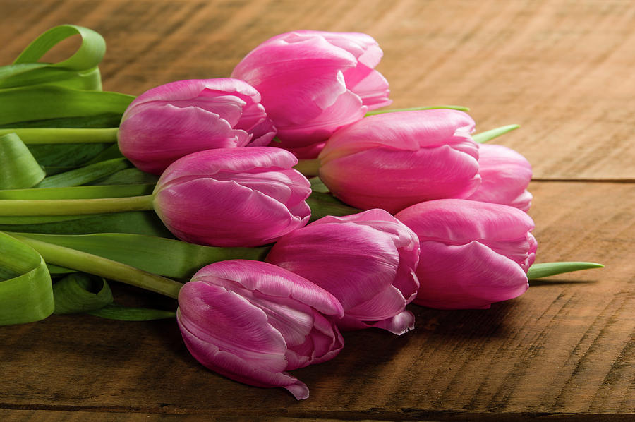 Bouquet of pink tulips on a wooden table #1 Photograph by John Trax