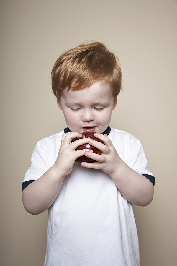 Boy, 3 years old, holding an apple. #1 Photograph by Dan Hallman