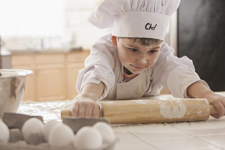 Boy baking in chefs whites #1 Photograph by Jose Luis Pelaez Inc