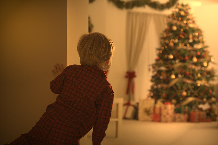 Boy looking at christmas tree #1 Photograph by Comstock Images