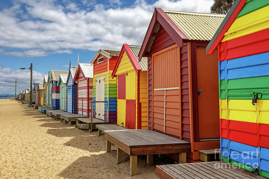 Brighton beach Victorian bathing boxes. Brightly painted colourful beach huts line the sand in Melbourne, Australia. They are highly desirable and extremely expensive real estate. #1 Photograph by Jane Rix