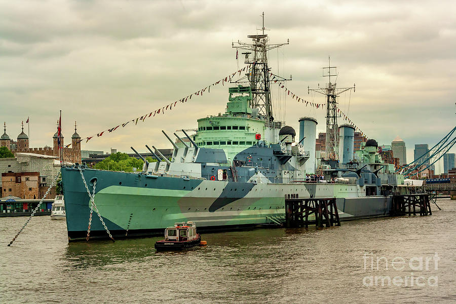 British battleship in rive thames with Tower bridge in the backg ...