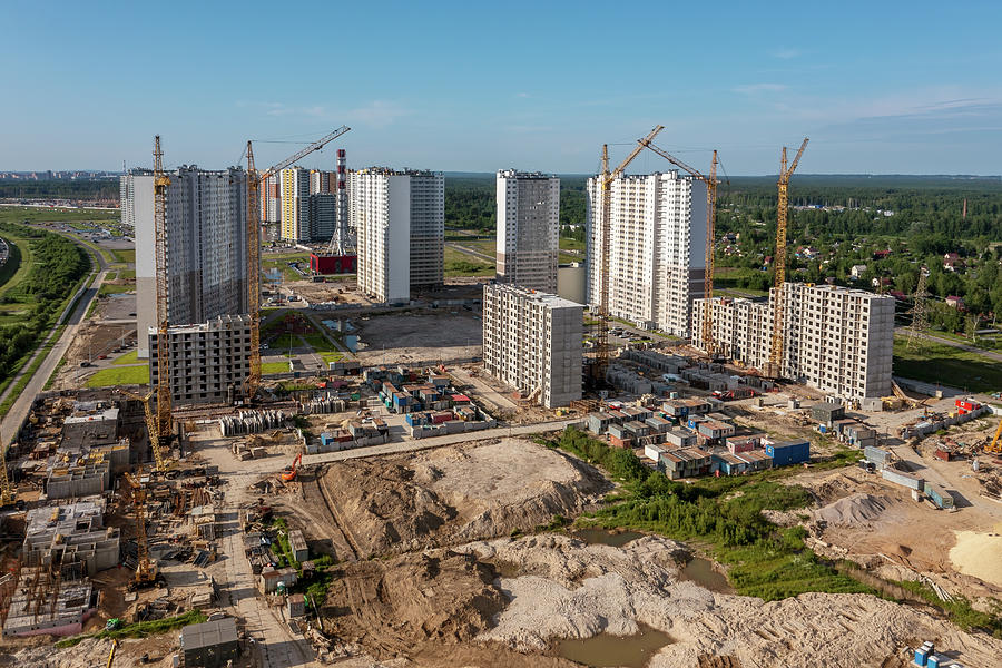 Building crane and buildings under construction #1 Photograph by Mikhail Kokhanchikov