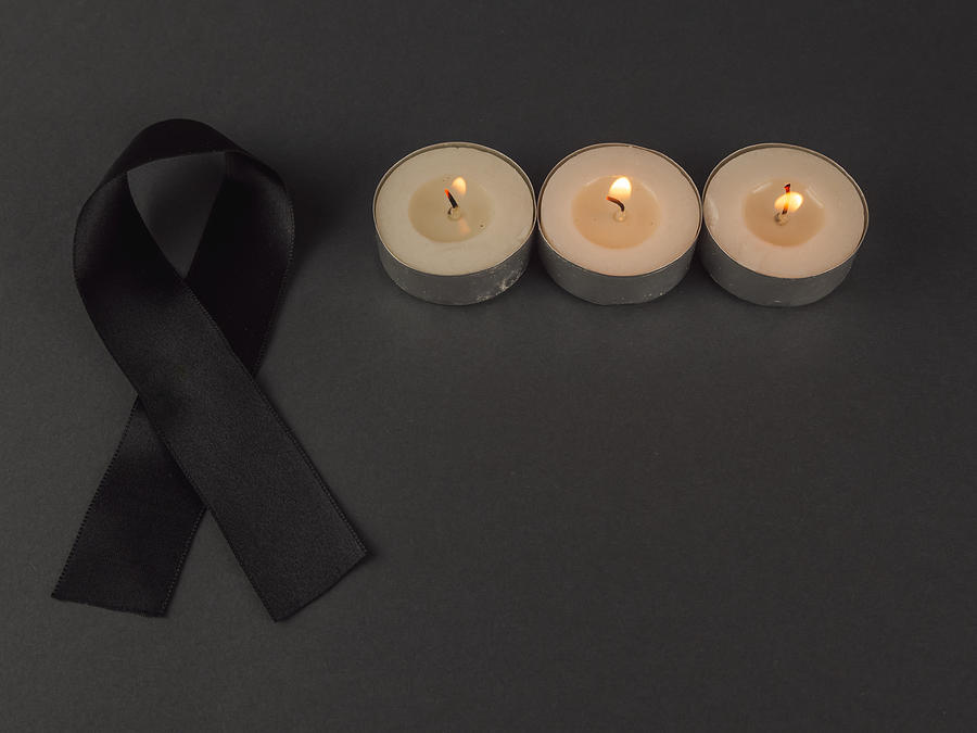 Burning candles and a black bow of black ribbon in mourning Photograph by Ana Maria Serrano