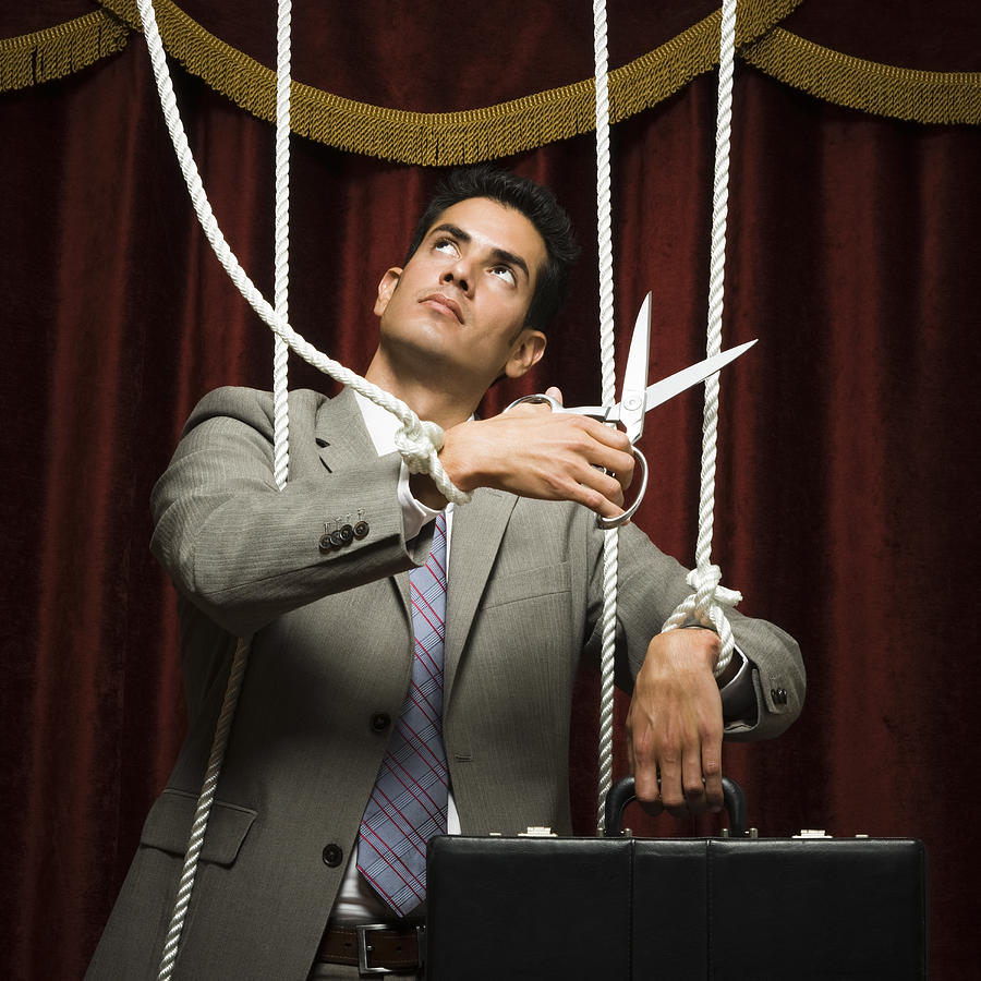 Businessman Being Pulled By Strings Like A Puppet #1 Photograph by RubberBall Productions