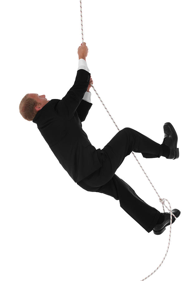 Businessman climbing rope #1 Photograph by 4x6