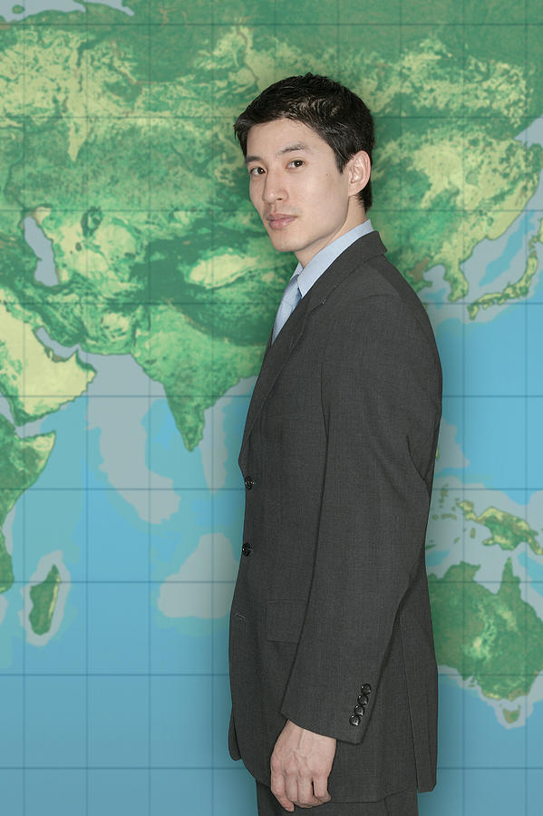 Businessman in front of world map #1 Photograph by Comstock Images