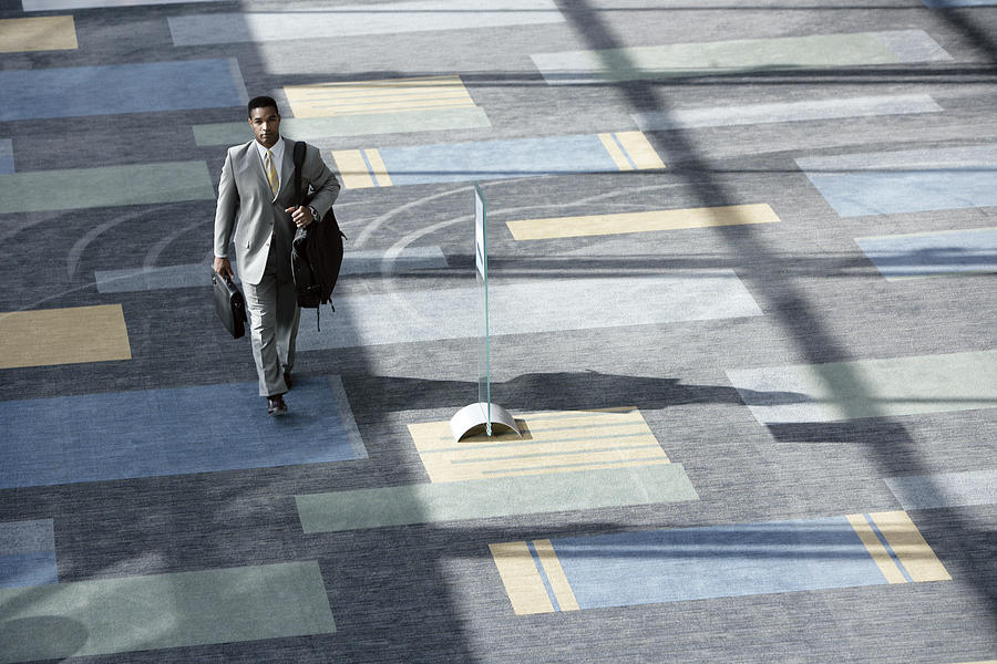 Businessman walking with luggage #1 Photograph by Comstock Images