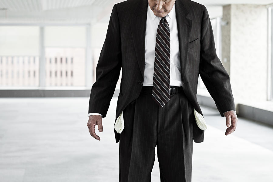Businessman with empty pockets #1 Photograph by Image Source