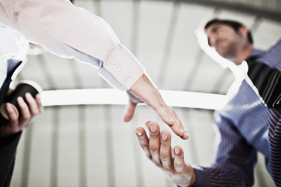 Businessmen shaking hands #1 Photograph by Tom Merton
