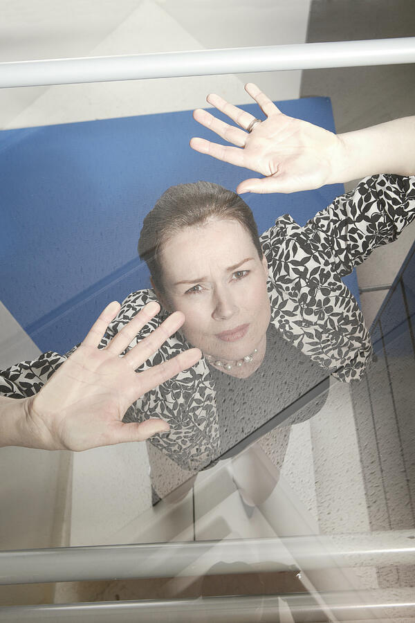 Businesswoman trapped under glass ceiling #1 Photograph by Comstock Images
