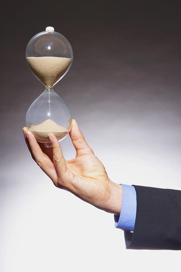 Caucasian businessman holding hourglass #1 Photograph by Jacobs Stock Photography Ltd