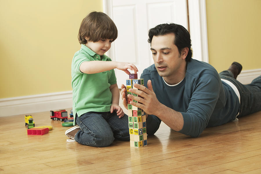 Caucasian father and son playing with alphabet blocks #1 Photograph by Jose Luis Pelaez Inc