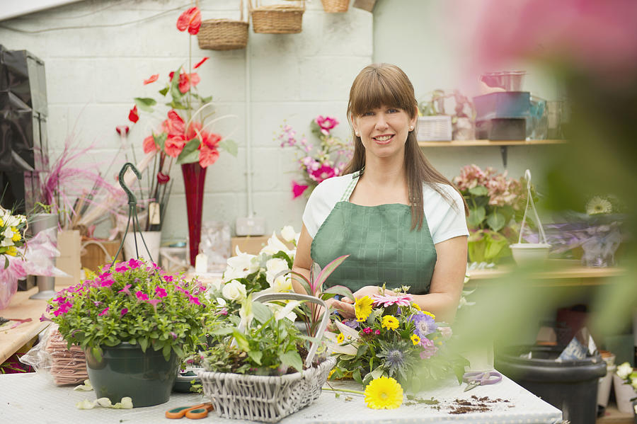 Caucasian florist working in flower shop #1 Photograph by Jacobs Stock Photography Ltd