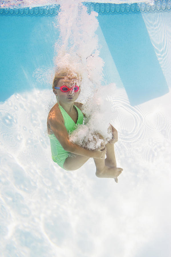 Caucasian girl swimming underwater in pool #1 Photograph by JGI/Jamie Grill