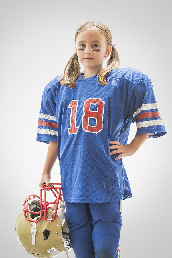 Caucasian girl wearing football jersey and helmet #1 Photograph by Jose Luis Pelaez Inc