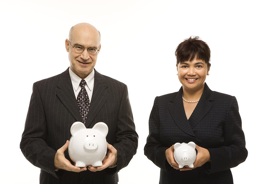 Caucasian middle-aged businessman and Filipino businesswoman holding different sized piggybanks. #1 Photograph by - Fotosearch