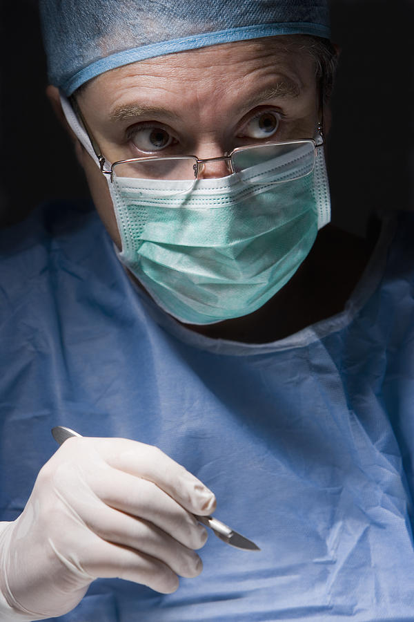Caucasian surgeon performing surgery #1 Photograph by Blend Images - REB Images