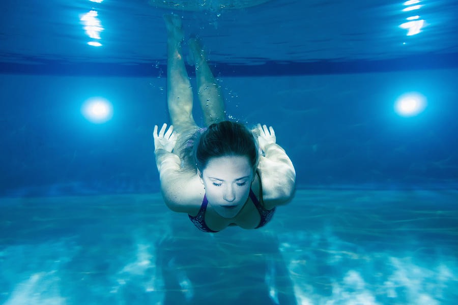 Caucasian woman swimming underwater in pool #1 Photograph by Jacobs Stock Photography Ltd
