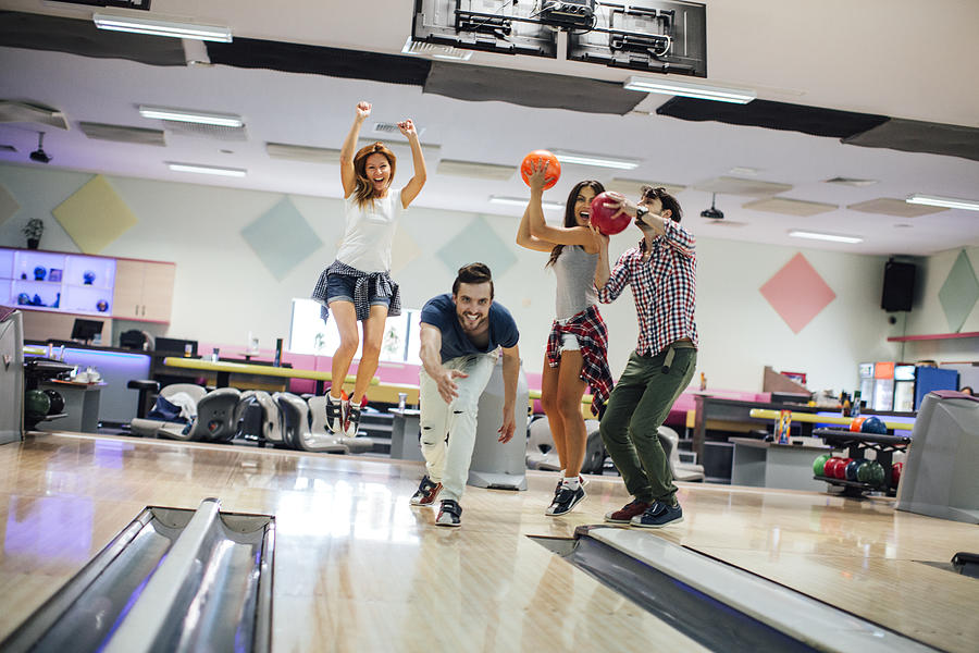 Cheerful Friends Bowling Together #1 Photograph by Vgajic